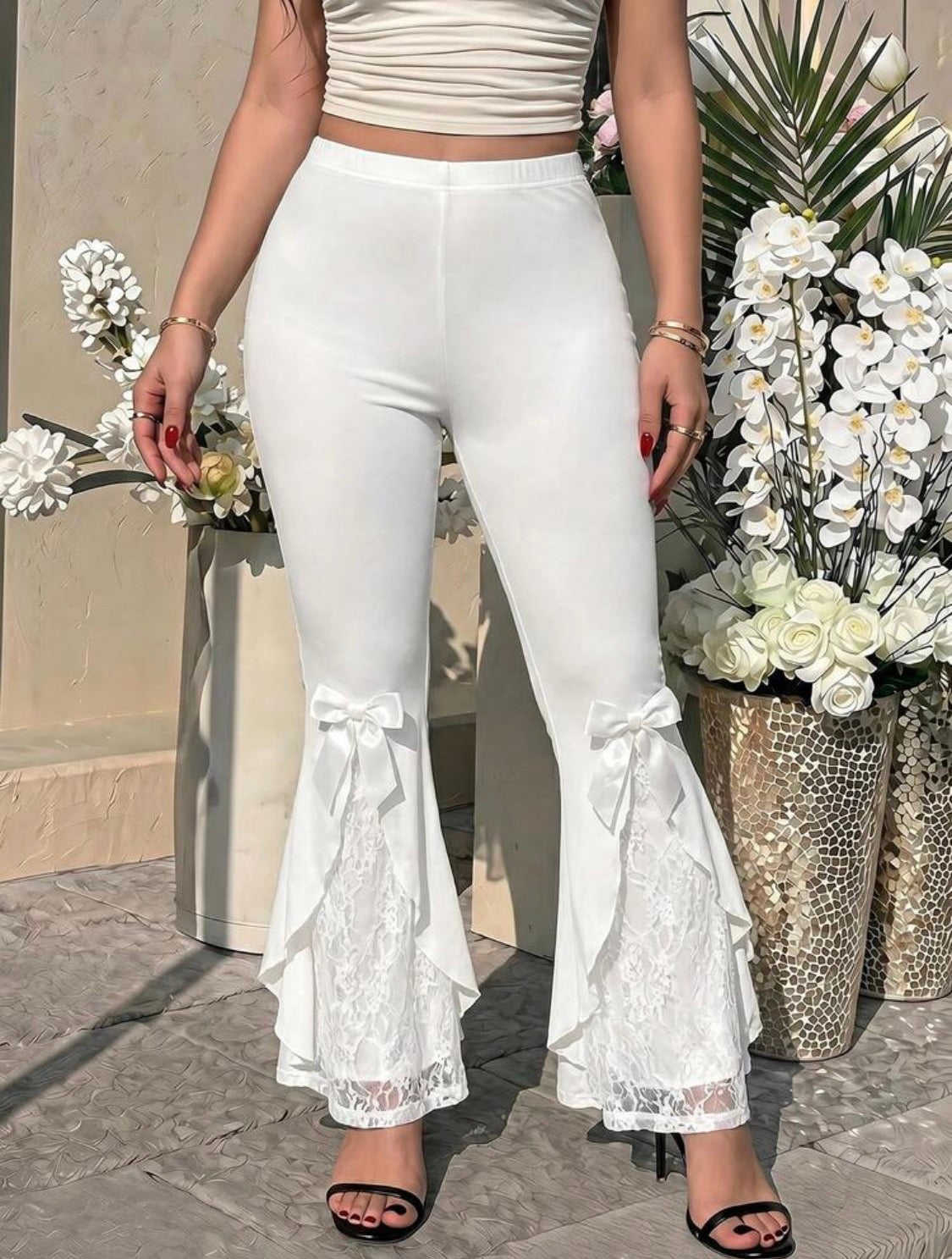 White lace flare trousers close up
